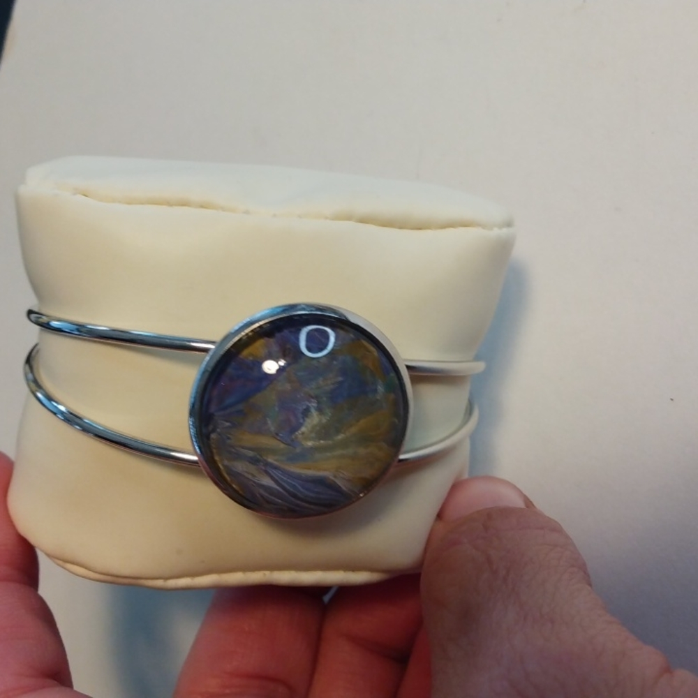 Silver cuff bracelet w/design by Ms Mels Creations w/colors purple,gold,silver